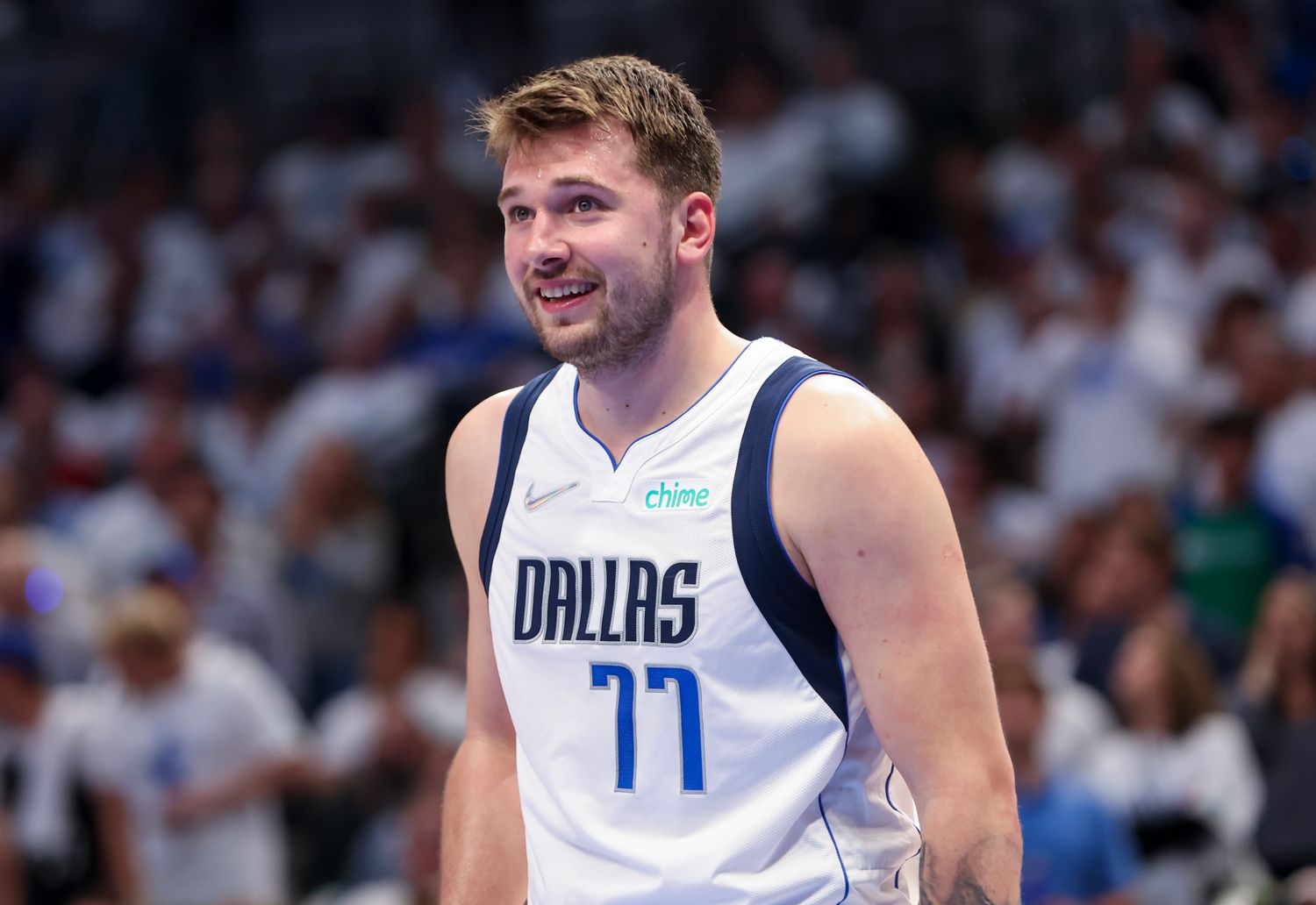 Luka Doncic smiles during a game.